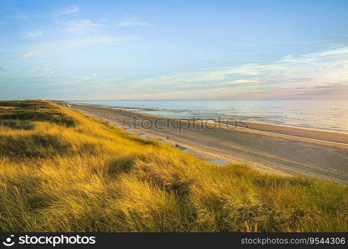 Inviting Sunset View over ocean from dune over North Sea. Outdoor scene of coast in nature of Europe.. Mesmerizing seascape during sunset in Zeeland, The Netherlands