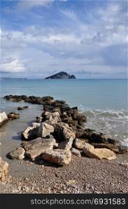 Ionian sea and blue sky horizon breakwater rocks and. View of Marathonisi islet from Keri beach in Zakynthos Greece.