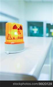 Ionizing radiation hazard symbol in x-ray laboratory, blurred laboratory interior for background.