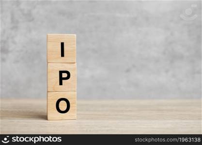 IPO (Initial Public Offering) word with wooden cube block, shares of a private corporation to the public in a new stock issuance. Stock, Fund, Investors and Investment concept