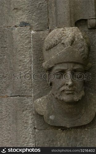 Ireland - Kilkenny - Sculpted face on side of stone wall