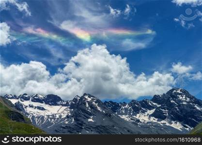 Iridescent cloud over the road to Stelvio pass, Sondrio province, Lombardy, Italy, at summer.