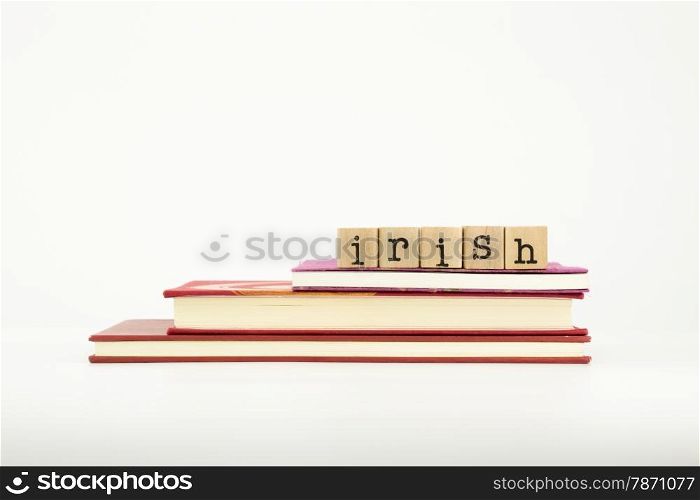 irish word on wood stamps stack on books, language and study concept