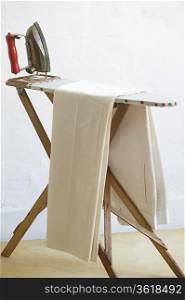 Iron and fabric on ironing board