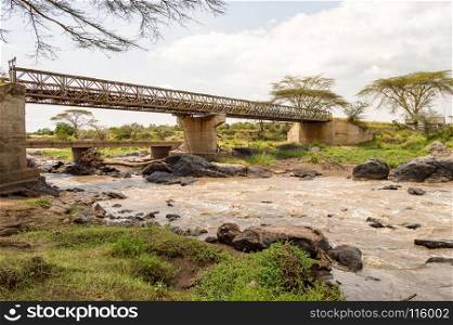 Iron Bridge on the Mara River between Maasai Mara. Iron Bridge on the Mara River between Maasai Mara Park in North West Kenya and Serenghetti Park in Tanzania