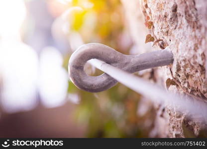 Iron piton in a rock, climbing sports