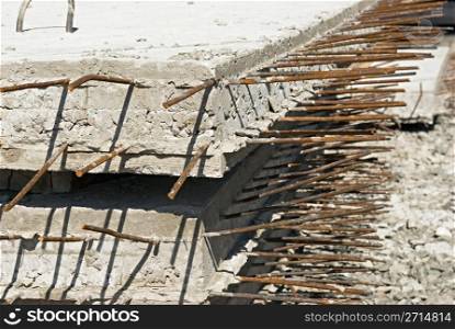 iron rods sticking out of concrete slabs