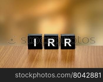 IRR or Internal Rate Of Return on black block with blurred background