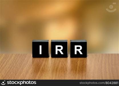 IRR or Internal Rate Of Return on black block with blurred background