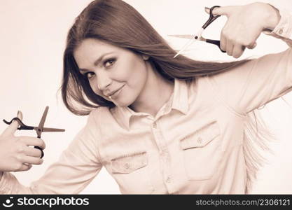 Irresponsibility danger haircut coiffure care beauty concept. Passionate female hairdresser. Cheerful lady dual wielding scissors showing her work tools normal and thinning shears. Passionate female hairdresser.