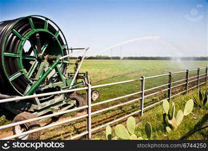 Irrigation operations in Italian country during a sunny day