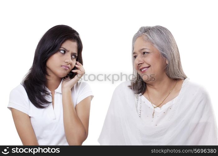Irritated teenage girl looking at her grandmother