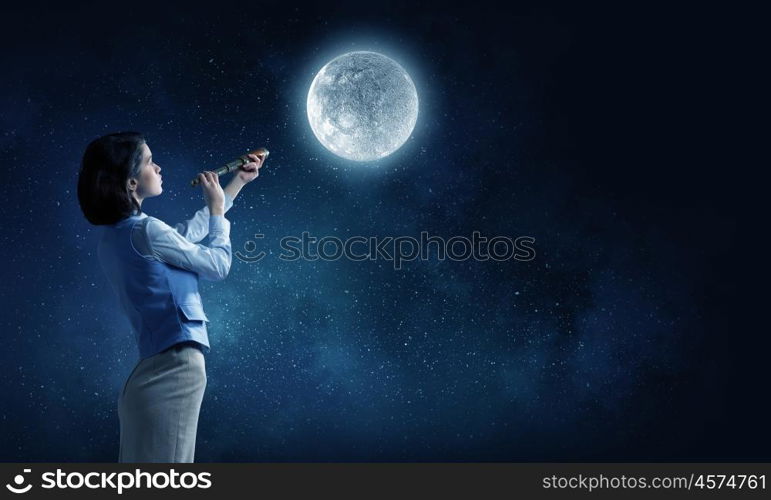 Is there life on moon. Young businesswoman looking in spyglass on full moon in sky