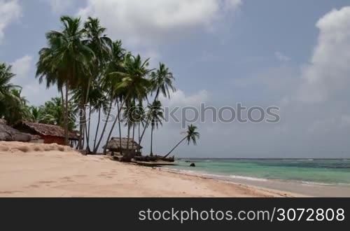 Isla Aguja, archipelago of San Blas islands, Panama, Central America. Coconut palms and house on white sand beach. Nature, hut on idyllic island, atoll, tropical paradise, sea, ocean, tropics, travel