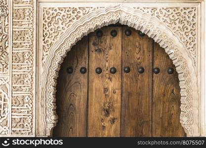 Islamic ornaments on wall. Arab symbols. Wooden door