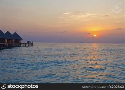 Island in ocean, Maldives. Sunset.