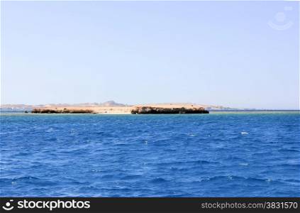 Island in the Sea. Sea Blue Water Background.