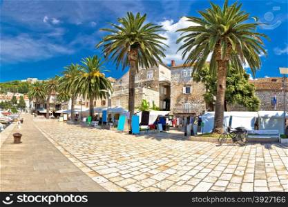 Island of Hvar palm waterfront with old stone architecture and walkway, Dalmatia, Croatia