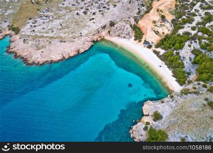 Island of Krk idyllic pebble beach with karst landscape aerial view, stone deserts of Stara Baska, Kvarner bay of Croatia