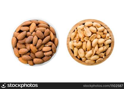 Isolated almonds in a white cup and roasted peanuts in a wooden cup on white background.