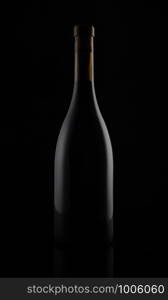 Isolated black matt wine bottle on dark background.. Isolated black matt wine bottle on dark background