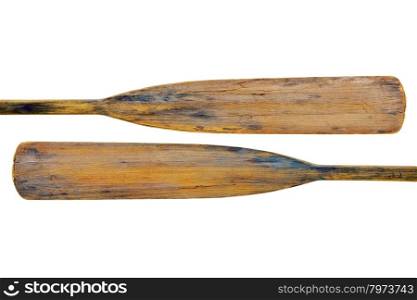 isolated blades of two old wooden weathered paddles (oars) with stains and cracks