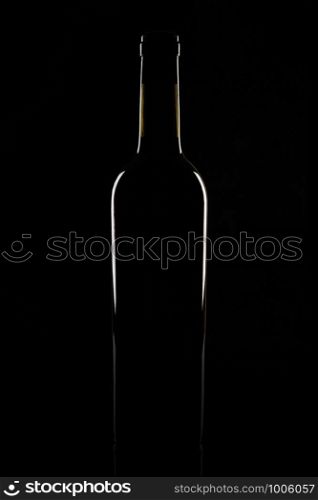 Isolated bordeaux wine bottle, dark background silhouette.. Isolated bordeaux wine bottle, dark background silhouette