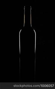 Isolated bordeaux wine bottle, dark background silhouette.. Isolated bordeaux wine bottle, dark background silhouette