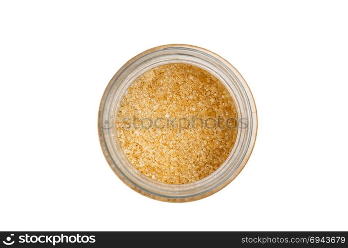 Isolated brown sugar in jar with white background.