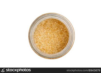 Isolated brown sugar in jar with white background.