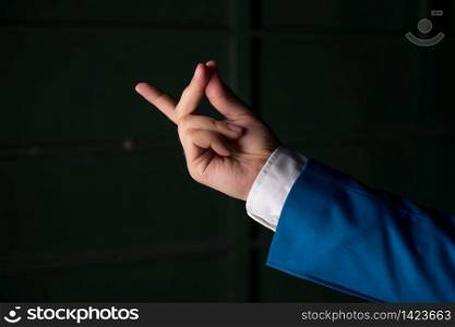 Isolated hand pointing with finger into copy space. Business concept with pointing finger.. Isolated hand pointing with finger into copy space. Business concept with pointing finger. Isolated hand above black background.