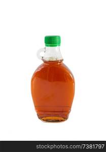 Isolated maple syrup in a bottle.. Isolated maple syrup in a bottle