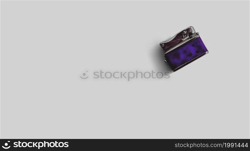 Isolated metallic lighter on grey background , added copy space for text.