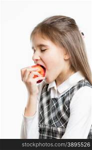 Isolated portrait of cute schoolgirl biting fresh red apple