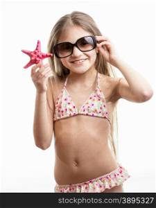 isolated portrait of happy smiling girl in sunglasses posing with red starfish