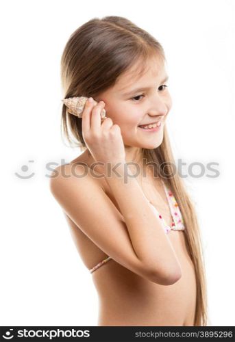Isolated portrait of happy smiling girl listening the seashell