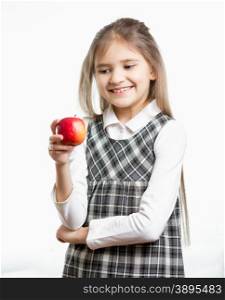 Isolated portrait of smiling schoolgirl looking at red apple