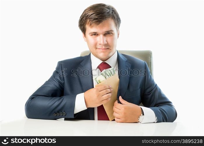 Isolated portrait of venal politician putting money in envelope in pocket of his suit