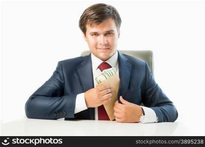 Isolated portrait of venal politician putting money in envelope in pocket of his suit