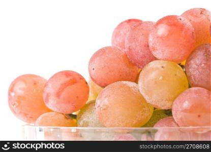 Isolated red grape fruit in glass bowl.