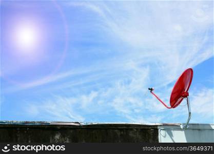 isolated red satellite on sunny blue sky