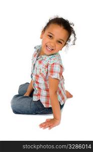 Isolated studio shot of a beautiful mixed race littkle girl sitting and laughing