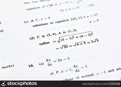 Isolated table of random numbers and formula on white paper background