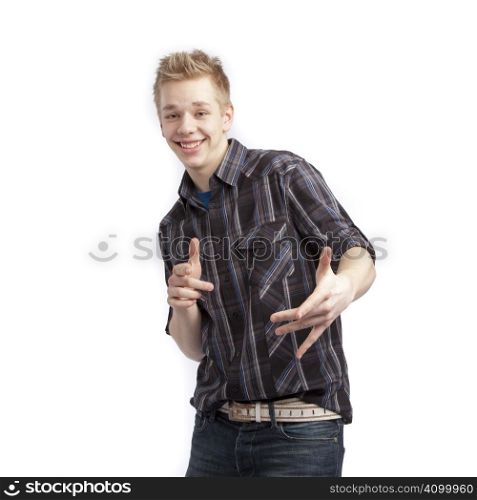 Isolated teen boy posing and pointing finger over white background