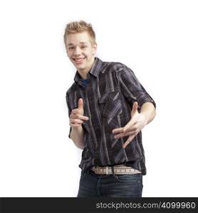 Isolated teen boy posing and pointing finger over white background