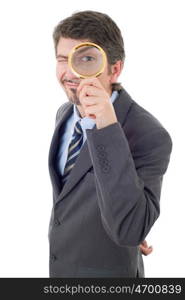 Isolated young business man with magnifying glass