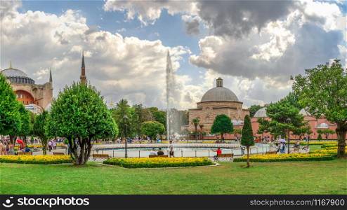 Istambul, Turkey ? 07.12.2019. The Sultan Ahmad Maydan water fountain with the Hagia Sophia museum in background on a cloudy summer day, Istanbul, Turkey. The Sultan Ahmad Maydan in Istanbul, Turkey