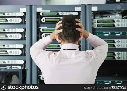 it business man in network server room have problems and looking for disaster situation solution.