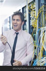 it business man in network server room have problems and looking for disaster situation solution