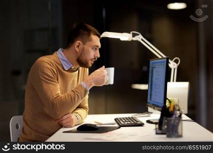 it, deadline and people concept - man with cup of coffee working on computer code at night office. man drinking coffee and working on code at office. man drinking coffee and working on code at office